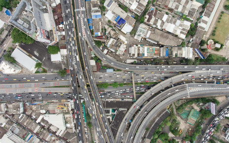 Aerial view of traffic jam in urban city. Top down view from up high. Afternoon day light shot. Congestion and urban life concept.