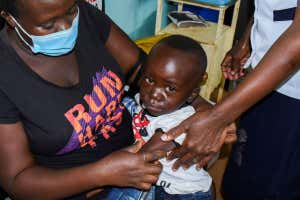 Jeywellan Ochieng, 2, reacts after receiving the vaccine against Malaria as she is held by her mother Julliet Achieng at the Yala Sub County Hospital Mother and Child Healthcare (MCH) clinic in Gem, Siaya County, Kenya October 7, 2021. REUTERS/James Keyi