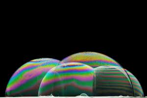 MN6GWA iridescence on the surface of some soap bubbles illuminated from below