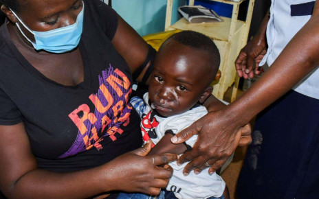 Jeywellan Ochieng, 2, reacts after receiving the vaccine against Malaria as she is held by her mother Julliet Achieng at the Yala Sub County Hospital Mother and Child Healthcare (MCH) clinic in Gem, Siaya County, Kenya October 7, 2021. REUTERS/James Keyi