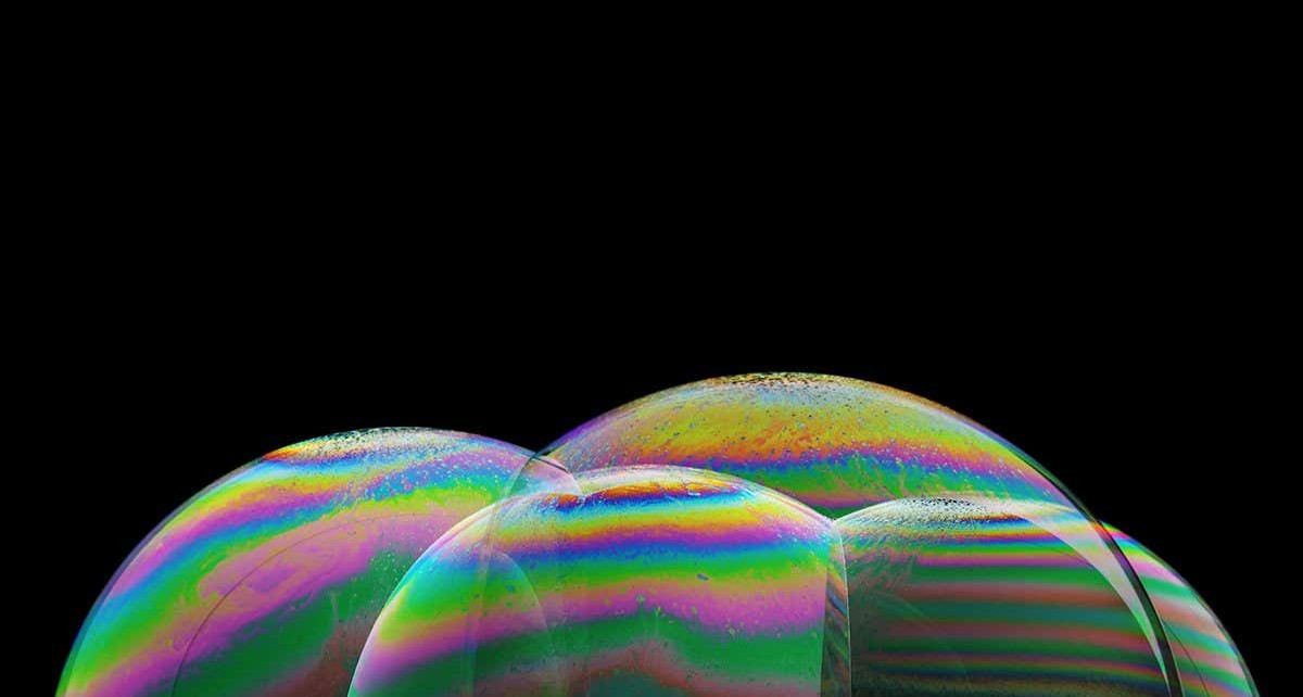 MN6GWA iridescence on the surface of some soap bubbles illuminated from below