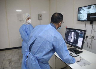 Mandatory Credit: Photo by CHINE NOUVELLE/SIPA/Shutterstock (10963111a) Dr. Mohammed Abdul-Hussein (R) and CT technician Hanan Jamal examine lung images at al-Shifaa Center in Baghdad, Iraq, Oct. 12, 2020. In a specialized COVID-19 hospital in Iraqi capital of Baghdad, a Chinese-donated CT scan, mobile X-ray equipment, and other medical supplies are saving lives in the front-line battle against the COVID-19 pandemic. Already 400 patients have benefited from the important medical donation. TO GO WITH &quot;Spotlight: Chinese-donated CT scan, mobile X-ray save lives in specialized COVID-19 hospital in Iraq&quot; Iraq Baghdad Hospital China Donation Ct Scan - 12 Oct 2020