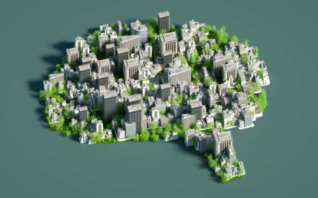 Digital generated image of Sustainable city in shape of human brain on green background.