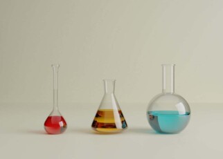 3d illustration. Set of a three small laboratory test tubes with different colored liquids on an isolated background. Science and laboratory equipment concept.
