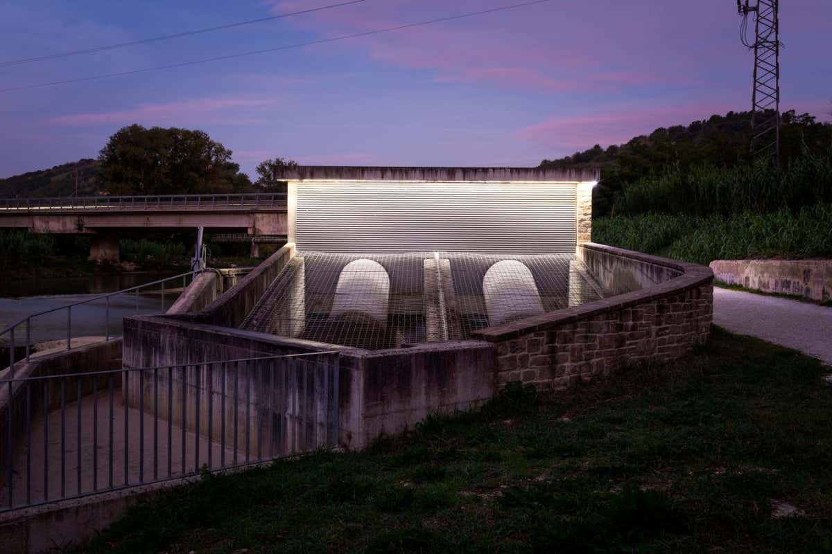 A hydroelectric plant on the Esino River at Angeli di Rosora, Ancona, Italy. Built in 2013, inside the building two hydraulic screws exploit the water current to produce electricity for the micro-grid of the "Leaf Community".