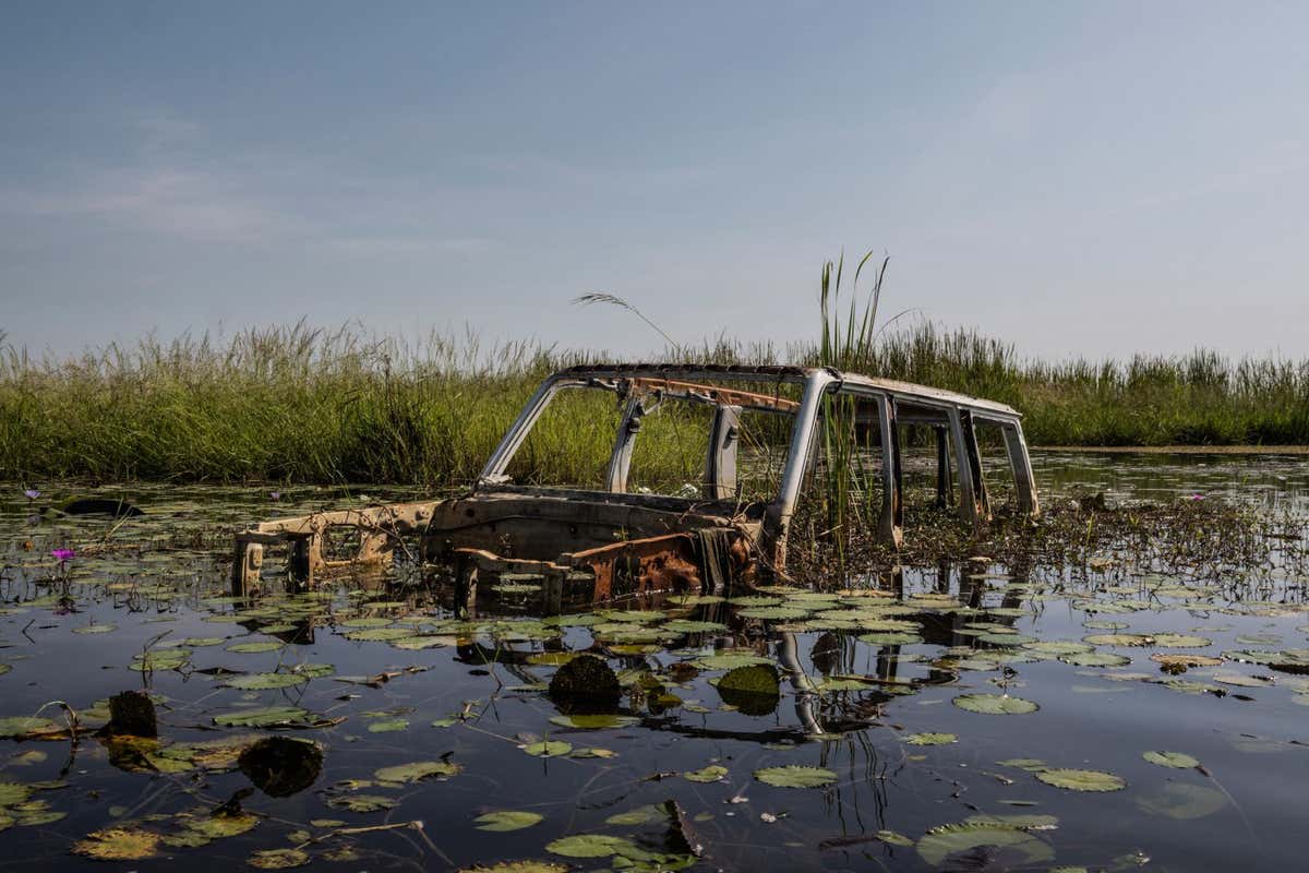 A car submerged by flood waters in Mayendit, Unity State, South Sudan, November 23, 2022. Unprecedented floods have submerged large swathes of the country and displaced hundreds of thousands of people. Mayendit is one of those villages which is disappearing underwater. In 2020 more than 12.000 people were living there, but in the last two years, two-thirds of them left it to eventually become internally displaced. ? Fabio Bucciarelli, Italy, 3rd Place, Professional competition, Landscape, Sony World Photography Awards 2023