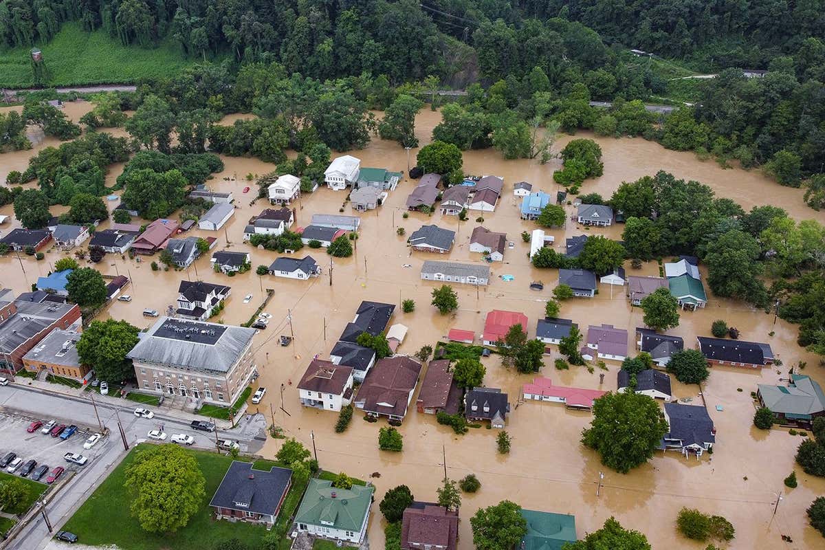 TOPSHOT - Aerial view of homes submerged under flood waters from the North Fork of the Kentucky River in Jackson, Kentucky, on July 28, 2022. - Flash flooding caused by torrential rains has killed at least eight people in eastern Kentucky and left some residents stranded on rooftops and in trees, the governor of the south-central US state said Thursday. (Photo by LEANDRO LOZADA / AFP) (Photo by LEANDRO LOZADA/AFP via Getty Images)