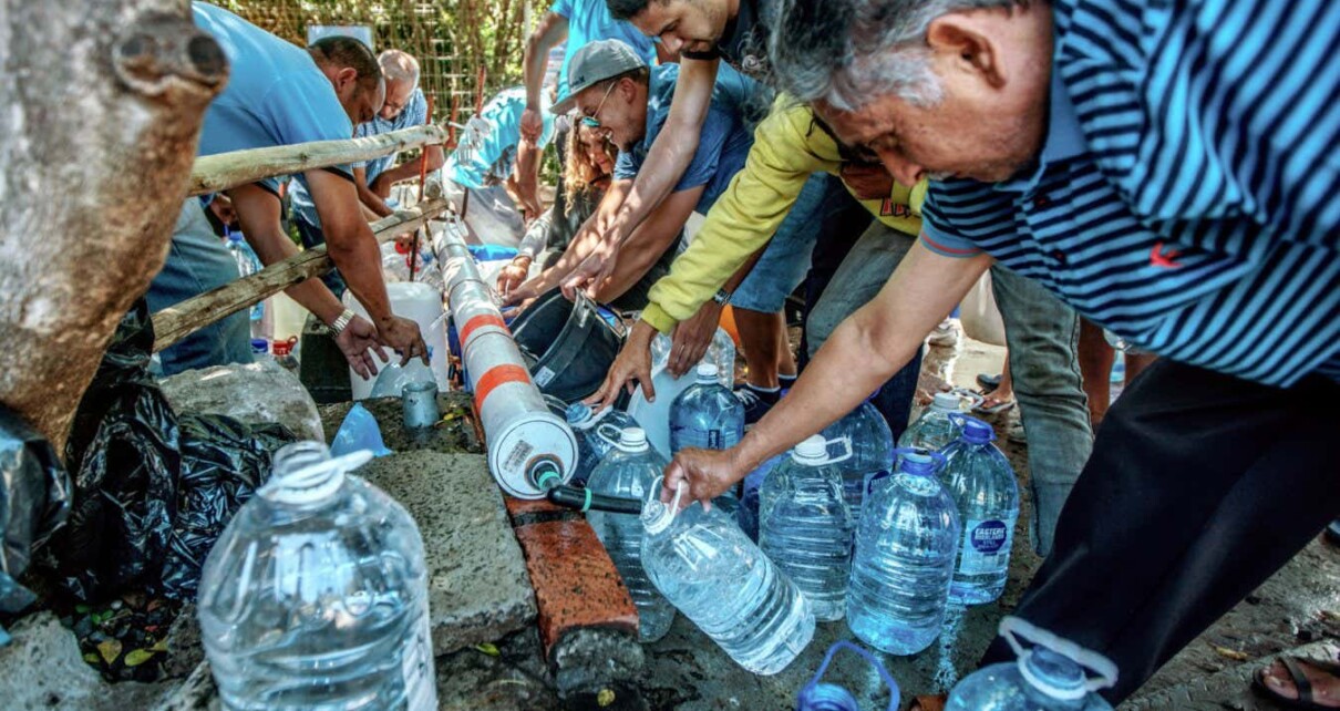 People in Cape Town, South Africa, refill water bottles at Newlands Spring in January 2018 amid the city's drought