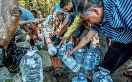 People in Cape Town, South Africa, refill water bottles at Newlands Spring in January 2018 amid the city's drought
