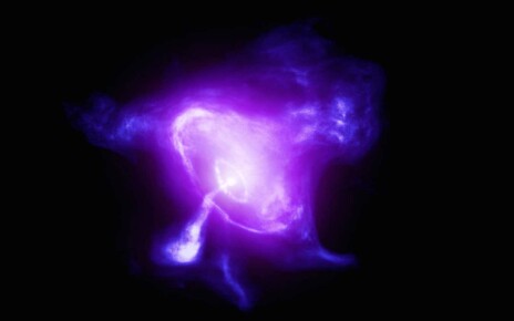A composite image of the Crab Nebula features X-rays (blue and white), optical data (purple), and infrared data (pink)