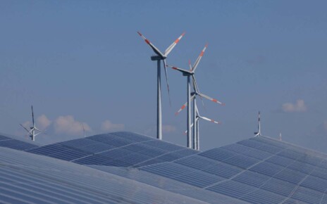Solar panels and wind turbines at a new solar park near Prenzlau, Germany