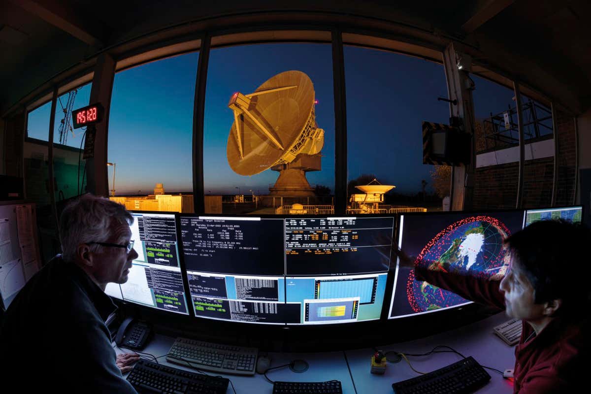 CHILBOLTON CONTROL ROOM, HAMPSHIRE, UK Station Manager Darcy Ladd and Emal Rumi look out over the main dish at the Chilbolton observatory, the UK?s main civilian satellite and debris tracking facility. Alongside monitoring the space environment, the observatory performs a wide range of scientific endeavours, including astronomy, atmospheric science and radiocommunications.