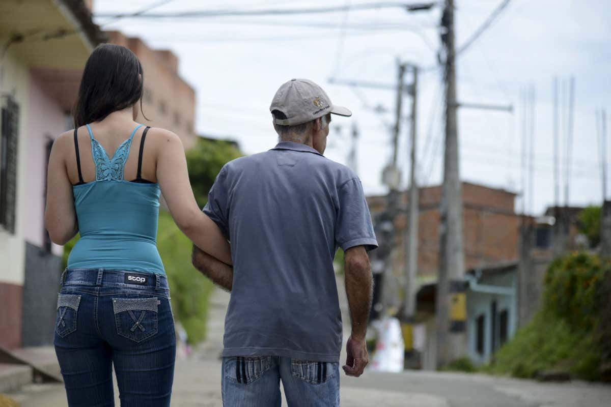 Someone with Alzheimer's walks with his daughter in Yarumal, north of Antioquia department, Colombia in 2014