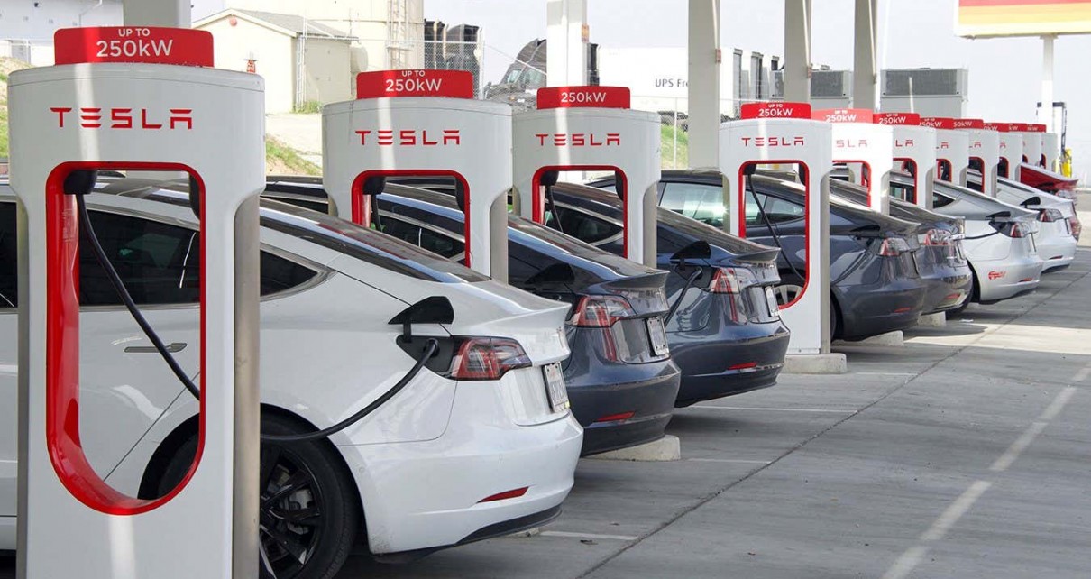 Kettleman City, CA - Jan 29, 2022: Many cars charging at a Tesla Supercharger station. Supercharger stations allow Tesla cars to be fast-charged at the network within a hour.