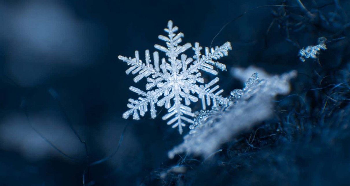 Snowflake on a dark blue background; Shutterstock ID 1006197640; purchase_order: -; job: -; client: -; other: -