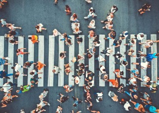 Aerial. People crowd on pedestrian crosswalk. Top view background. Toned image.