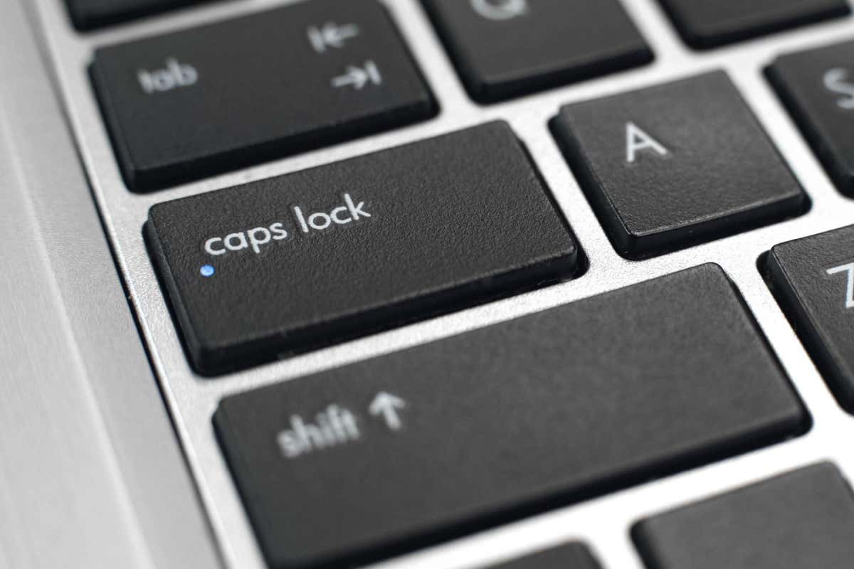 2AN93AM Switched on caps lock button on keyboard, typing capital letters, toggle key