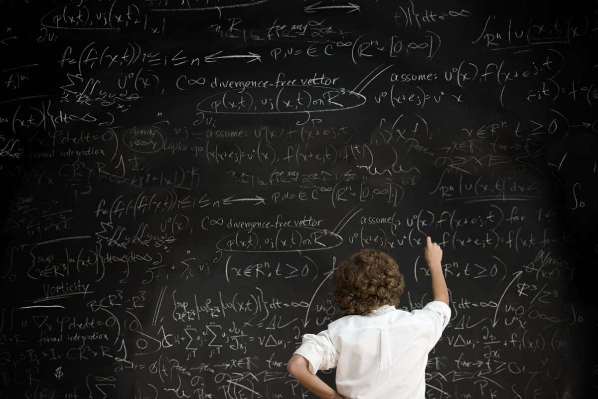 BAM2G8 Boy with formulae on blackboard