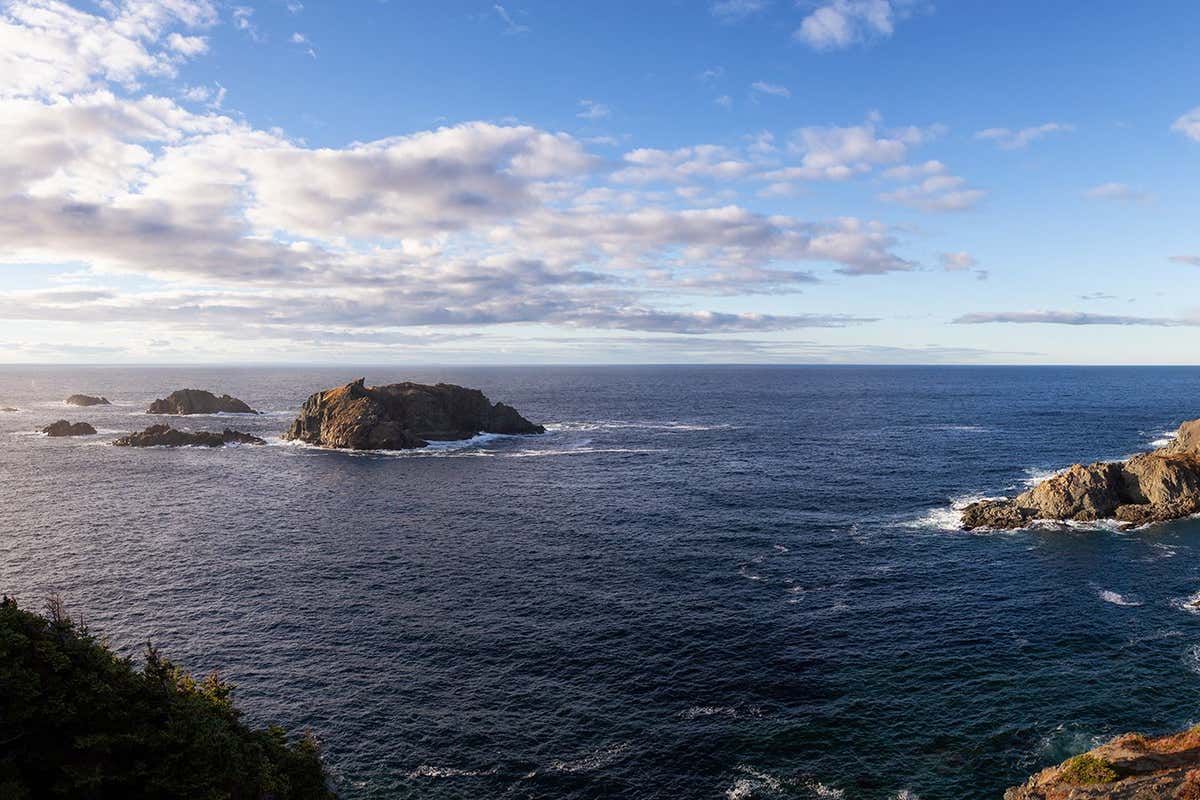 Striking panoramic seascape view on a rocky Atlantic Ocean Coast during a vibrant sunset. Taken at Crow Head, North Twillingate Island, Newfoundland and Labrador, Canada.