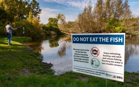 A sign on the Huron river in Michigan warning of high levels of PFAS