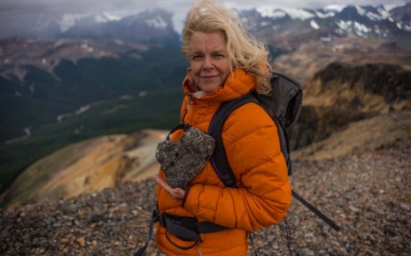 Kris Tompkins holds up a heartshaped rock during her hike up the mountain range in Patagonia, Chile. (Jimmy Chin)