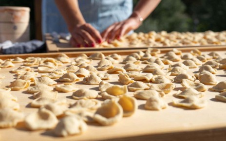 Ostuni, Puglia, Italy - 05 20 2022: Preparation of typical handmade pasta called "Orecchiette" in an outdoor space during the sunset light; Shutterstock ID 2158414957; purchase_order: -; job: -; client: -; other: -