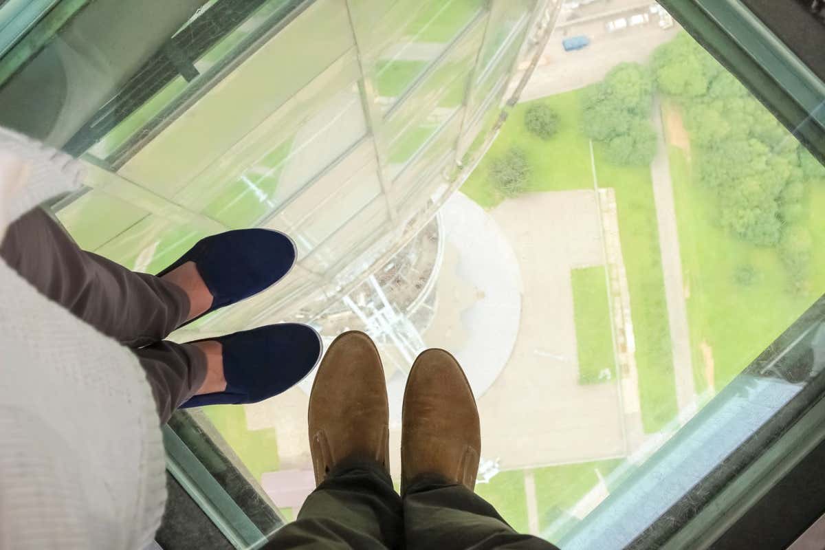 People standing on a glass floor at the Ostankino tower in Moscow, Russia