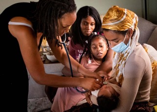 , CA - May 26:Aysha-Samon Stokes and her daughter Nyla, 6, watch Midwife Allegra Hill and student Midwife Maryam Karim take the heartbeat of two-week-old Nikko during a postpartum visit to the South Los Angeles birthing center, Kindred Space LA, on Wednesday, May 26, 2021 where he was born on Mothers Day night. With fear of another C-section and fear of the high mortality rate in the hospitals among women like herself Stokes found her midwife in her third trimester. (Photo by Sarah Reingewirtz/MediaNews Group/Los Angeles Daily News via Getty Images)