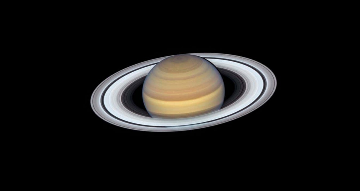 Release Date September 12, 2019 10:00AM (EDT) Caption Anyone who has ever peered at Saturn through a small telescope is immediately enticed by its elegant rings, which make the far-flung planet one of the most exotic-looking, opulent worlds in the solar system. The latest view of Saturn from NASA's Hubble Space Telescope captures exquisite details of the ring system?which looks like a phonograph record with grooves that represent detailed structure within the rings?and atmospheric details that once could only be captured by spacecraft visiting the distant world. One such intriguing feature is the long-lasting hexagon-shaped structure circling the planet's north pole. It is a mysterious six-sided pattern caused by a high-speed jet stream. NASA's Voyager 1 spacecraft first discovered the "hexagon" during its flyby in 1981. The hexagon is so large that four Earths could fit inside its boundaries. (There is no similar structure at Saturn's south pole.) Other features, however, are not as long lasting. A large storm in the north polar region spotted by Hubble last year has disappeared. Smaller, convective storms?called super "thunderheads"?such as the one just above the center of the planet's image, also come and go.