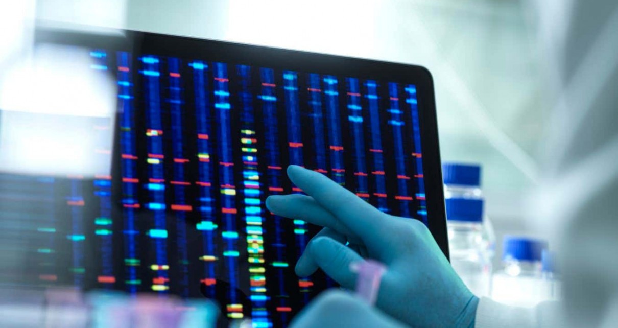 Scientist examining DNA results on a screen