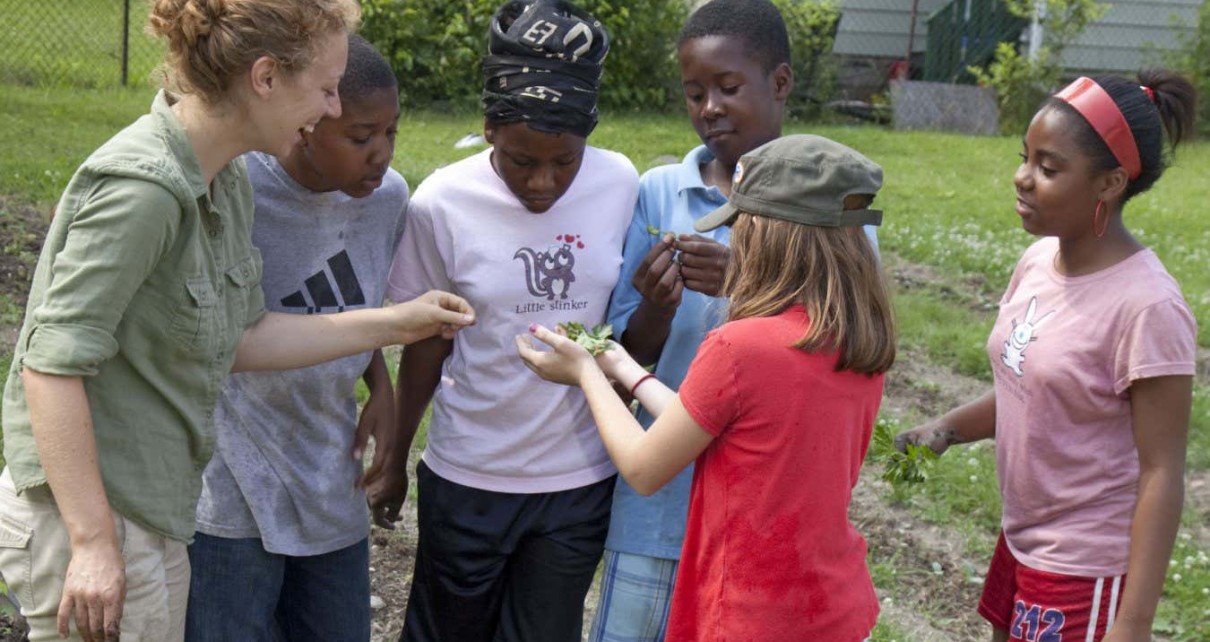 Mandatory Credit: Photo by Jim West/imageBROKER/Shutterstock (4549809a) Children inspect a caterpillar found in their garden which is tended by children ages 5-11 in a program called Growing Healthy Kids, as part of the Earthworks Urban Garden, which grows food for the Capuchin Soup Kitchen, Detroit, Michigan, USA VARIOUS