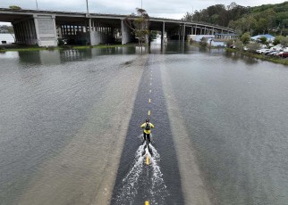 Commuter on a bike in floods