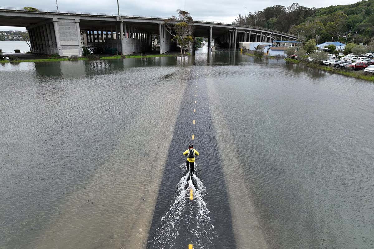 Commuter on a bike in floods