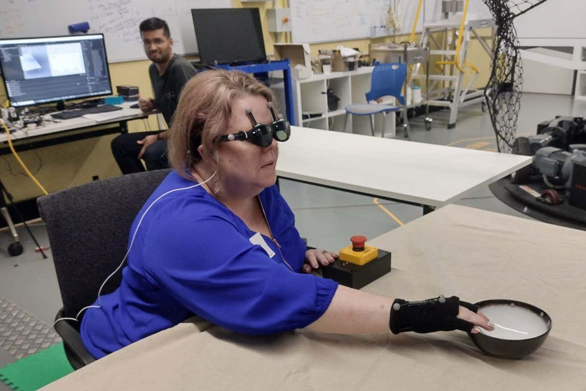 A person who is blind can detect a bowl is in front of her while wearing a pair of smart glasses
