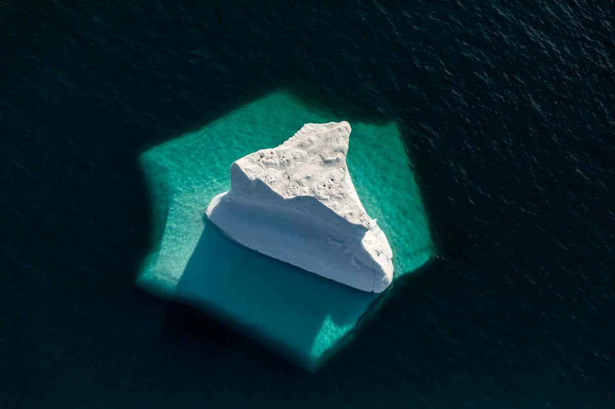 Iceberg showing submerged section when viewed from above, Greenland's National Park, Northeast Greenland. August 2015.