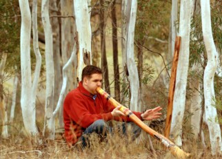 A man playing a digeridoo