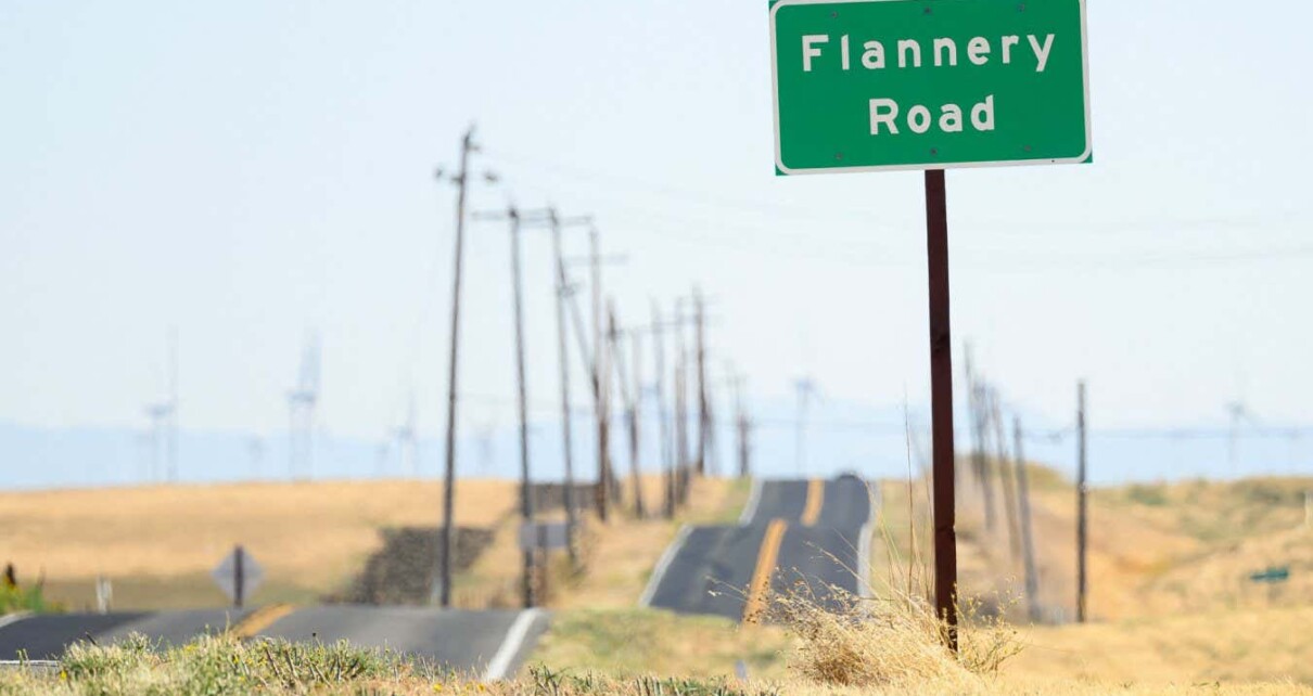 A road sign is posted near a parcel of land recently purchased by Flannery Associates near Rio Vista, California on September 15, 2023. A stealth campaign by Silicon Valley elites with a dream of turning a swath of California farmland into a new age city has ranchers who live here challenging their tactics as well as their motives. The project first surfaced when a mysterious buyer started gobbling up parcels of land in this rural outback between San Francisco and Sacramento. The buyer, first revealed by the New York Times in August, turned out to be a secretive outfit called Flannery Associates. (Photo by JOSH EDELSON / AFP) (Photo by JOSH EDELSON/AFP via Getty Images)