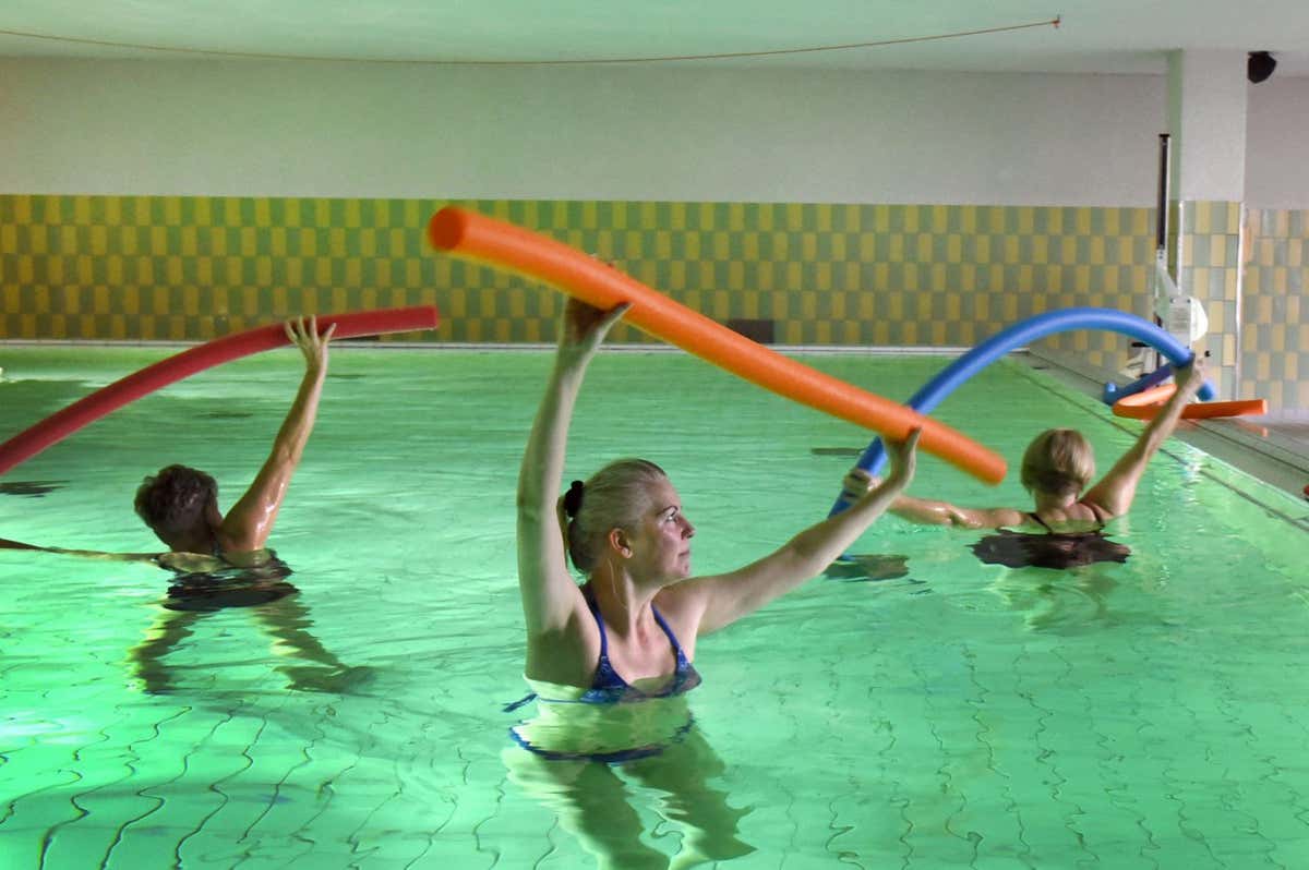 People with long covid, who were not participants in the latest trial, take part in an exercise programme in a swimming pool
