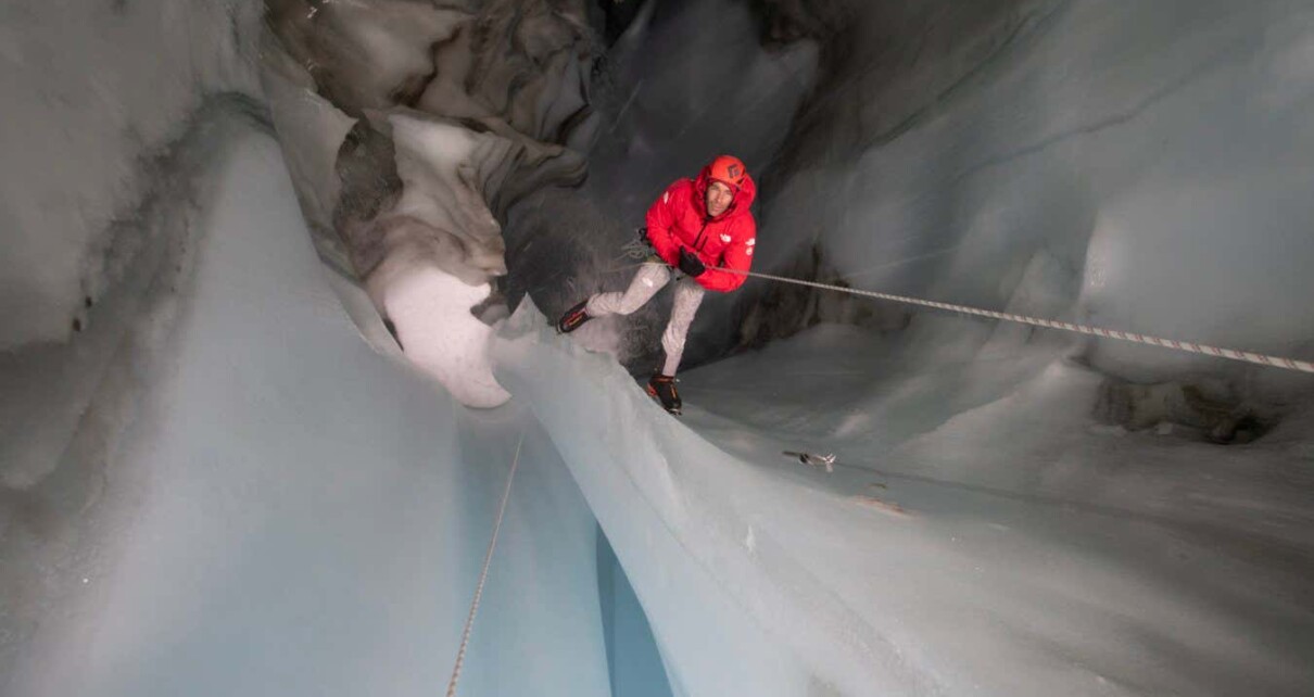 National Geographic handout picture: Arctic Ascent with Alex Honnold. Alex Honnold in a moulin. (photo credit: National Geographic/Mikey Schaefer)