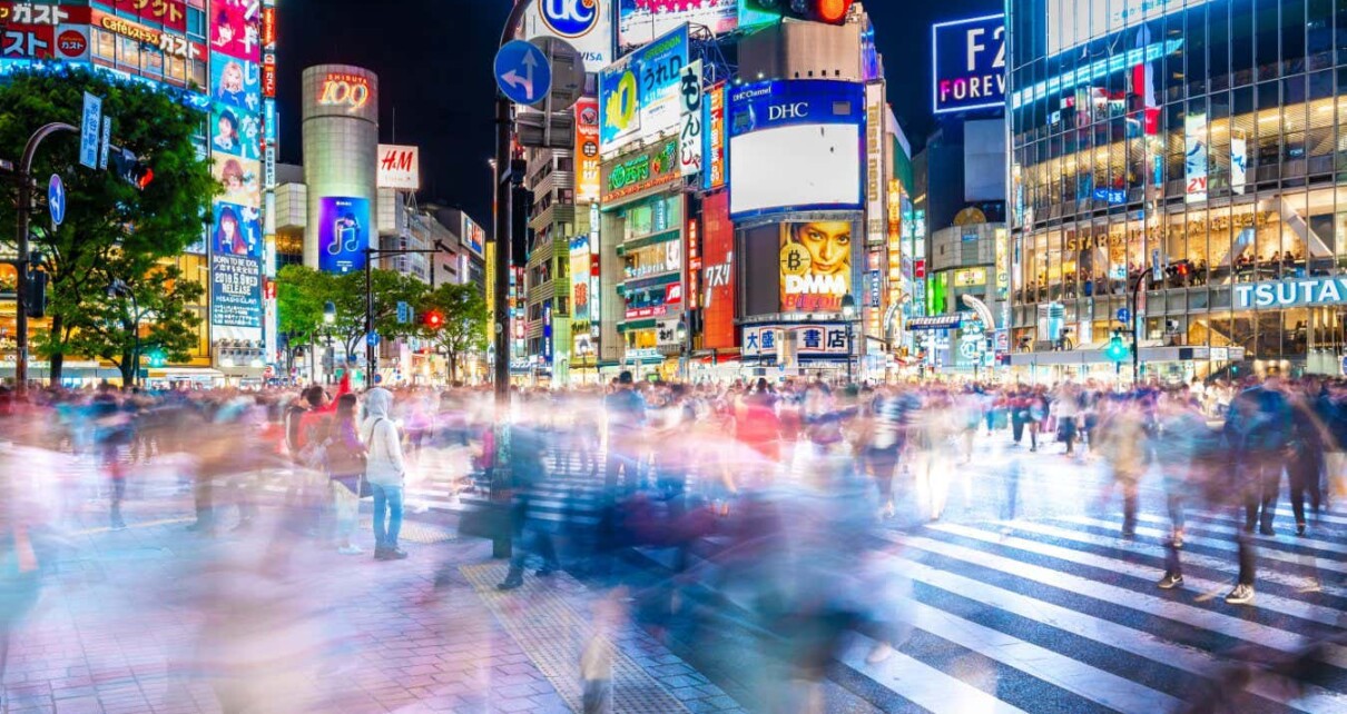 SHIBUYA, TOKYO, JAPAN-April 15, 2018: Crowds crossing Shibuya scramble crossing, the famous intersection in Tokyo out side Shibuya station, at night.; Shutterstock ID 1088019044; purchase_order: -; job: -; client: -; other: -