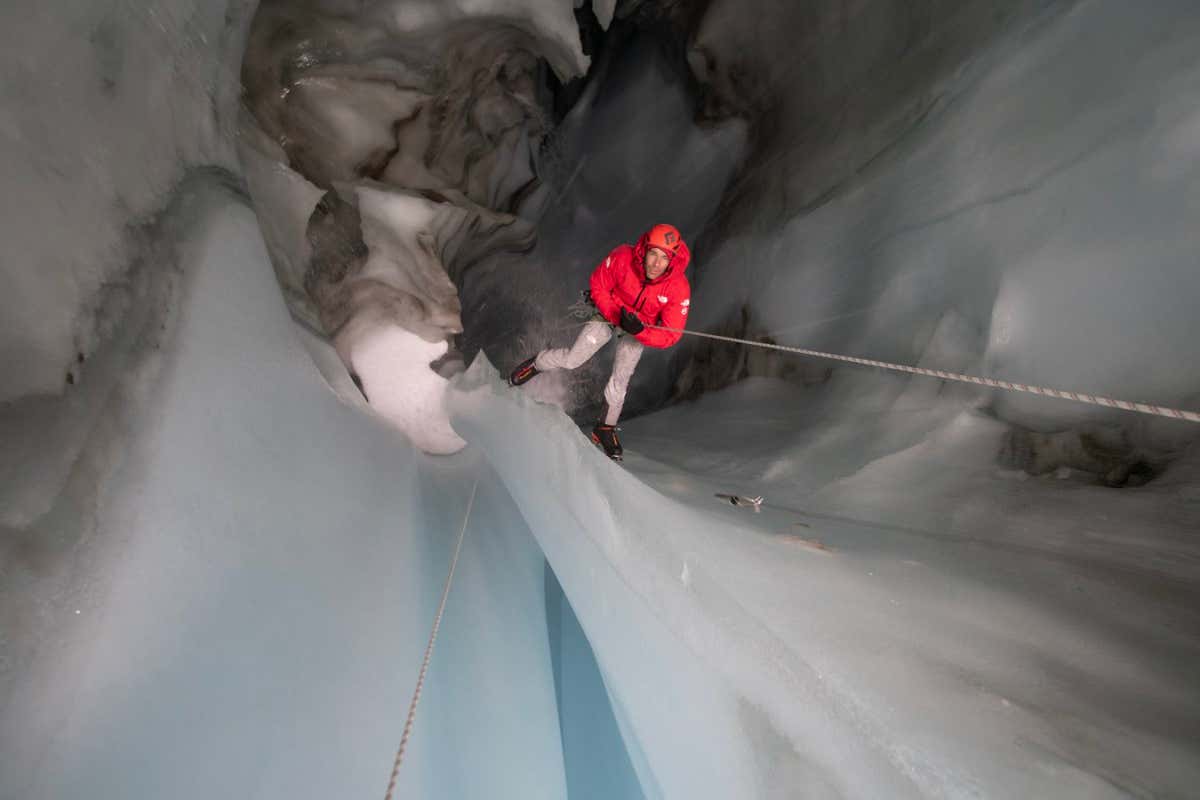 National Geographic handout picture: Arctic Ascent with Alex Honnold. Alex Honnold in a moulin. (photo credit: National Geographic/Mikey Schaefer)