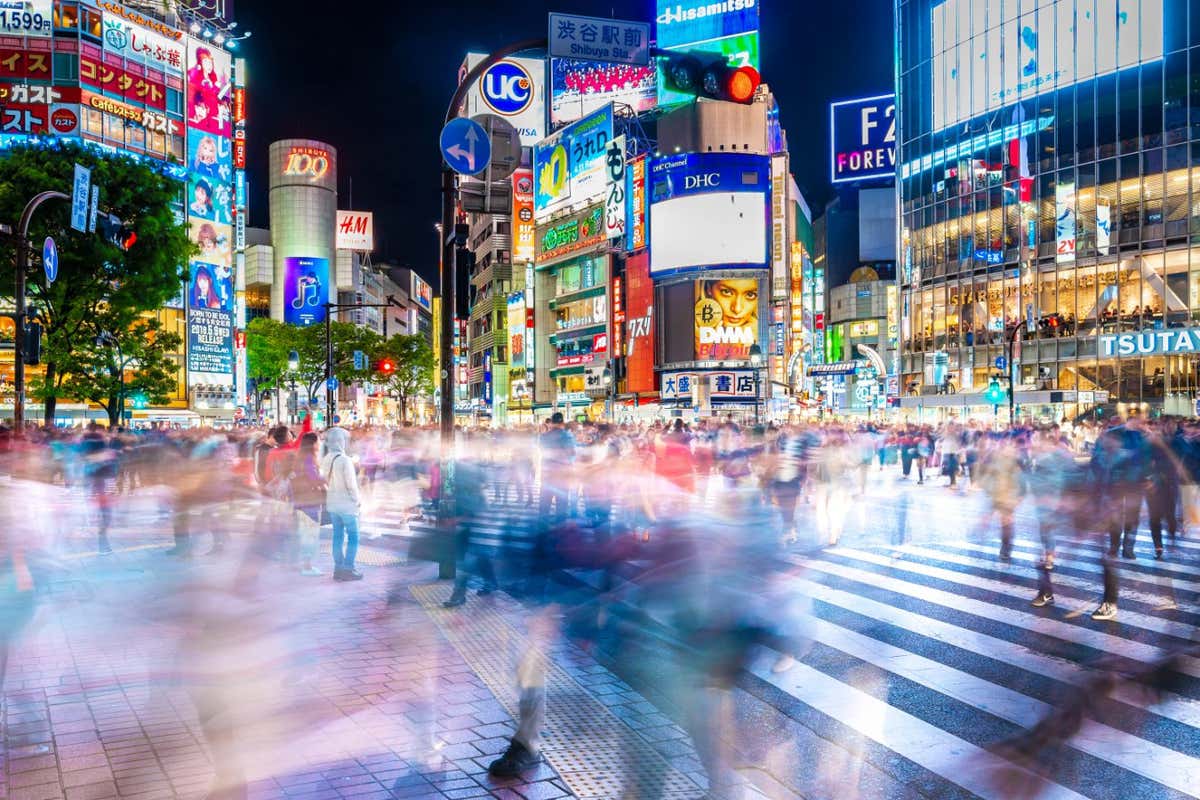 SHIBUYA, TOKYO, JAPAN-April 15, 2018: Crowds crossing Shibuya scramble crossing, the famous intersection in Tokyo out side Shibuya station, at night.; Shutterstock ID 1088019044; purchase_order: -; job: -; client: -; other: -