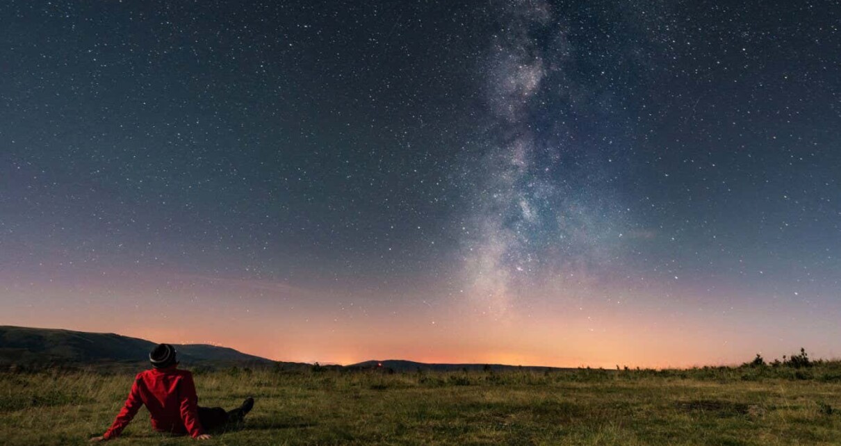 A young man lying on the grass and watching the Milky Way. Taken in A Veiga, Orense.