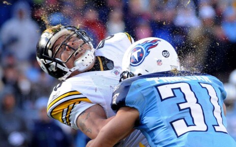 2P7YWKC FILE -- This is a Dec. 21, 2008, file photo showing grass and dirt flying as Pittsburgh Steelers wide receiver Hines Ward, left, is hit by Tennessee Titans' Cortland Finnegan (31) as Ward scores a touchdown on a 21-yard reception in the third quarter of an NFL football game in Nashville, Tenn. (AP Photo/John Russell, File)