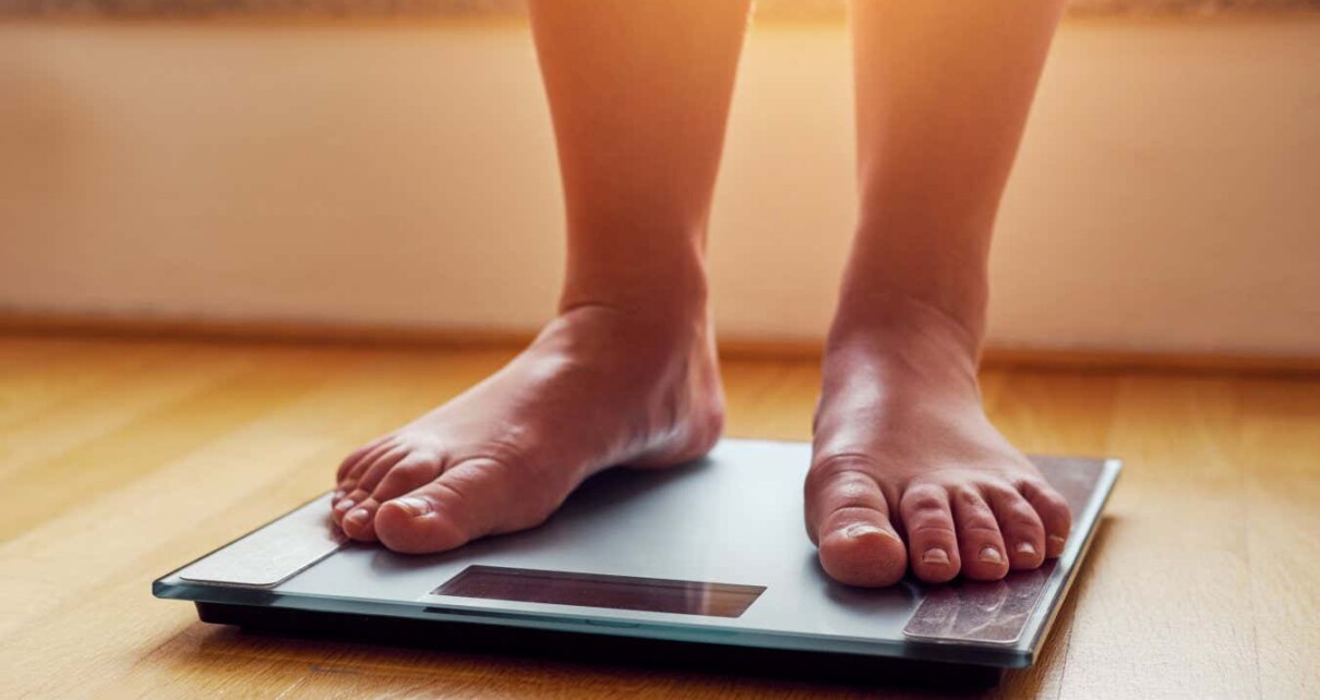 Female bare feet on weight scale