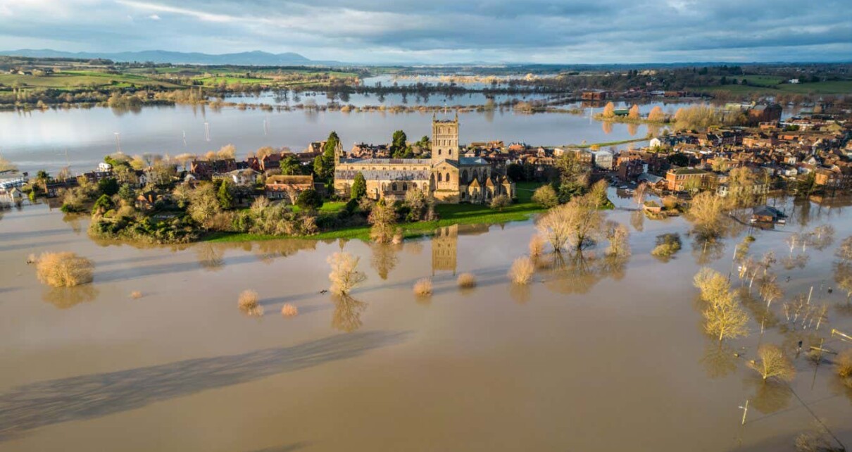 TEWKESBURY, UNITED KINGDOM - JANUARY 05: Flood water surrounds Tewkesbury Abbey and surrounding streets because of widespread flooding after the Rivers Swilgate and Avon burst their banks on January 5, 2024 in Gloucestershire, England. Storm Henk brought strong winds and heavy rain across much of the country this week which lashed large parts of the country, hitting travel and cutting power. While across the UK numerous flood warnings were still in place after weeks of heavy rainfall, the UK's Environment Agency has warned people to expect flooding to become more frequent because of climate change. (Photo by Anna Barclay/Getty Images)