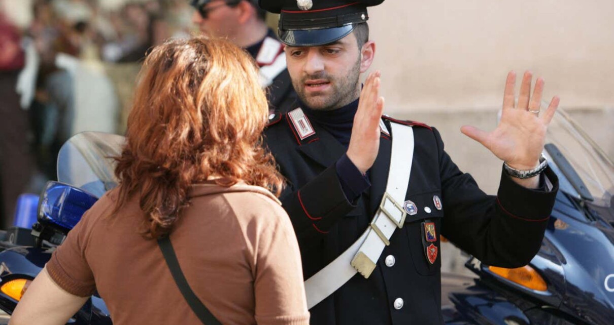 A police officer in Rome, Italy, gesturing to a tourist