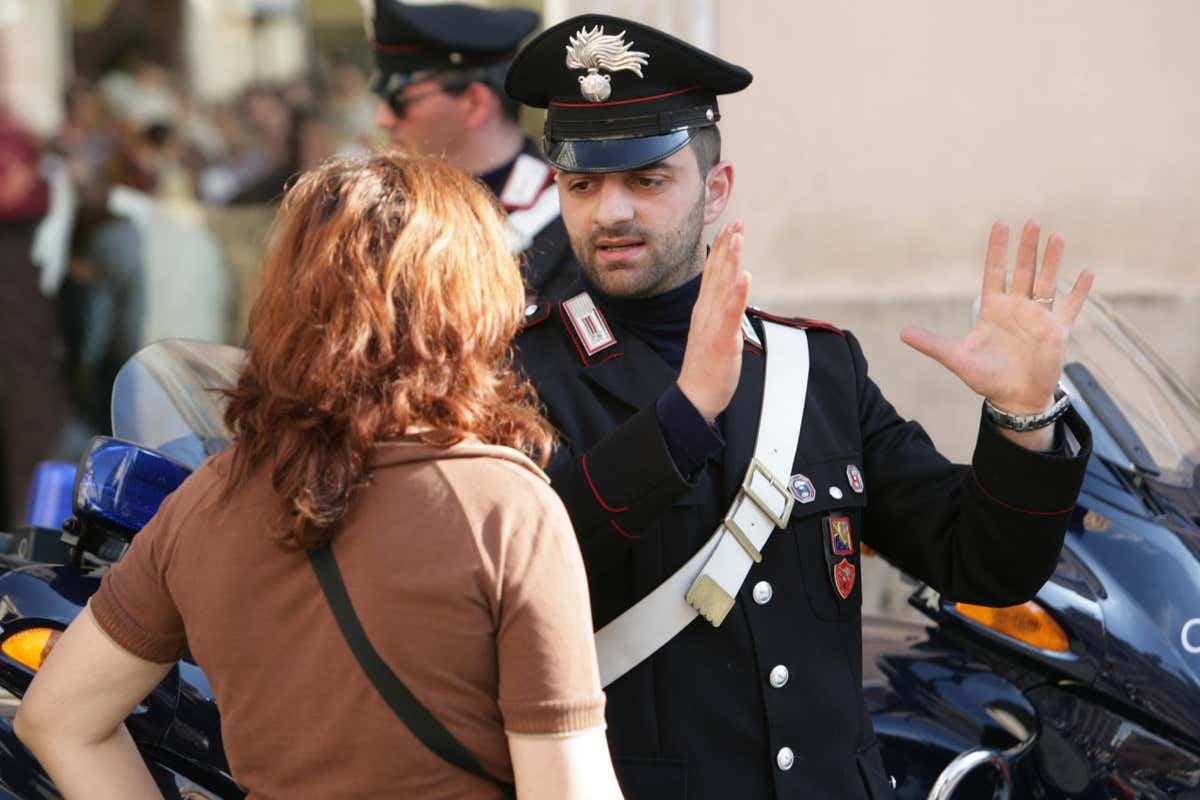 A police officer in Rome, Italy, gesturing to a tourist