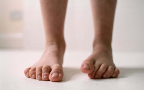 Child???????s Bare Feet DESCRIPTION Low section of child's bare feet against neutral background